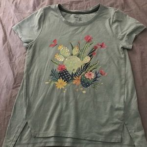 A children’s tee shirt with a floral design.